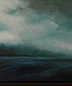 Misty mountain landscape over a dark lake in moody blue tones.