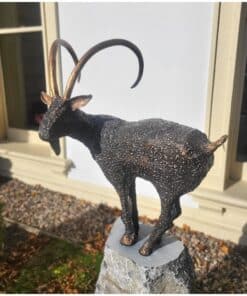 Bronze goat sculpture on stone pedestal at The Kildare Gallery, showcasing unique artwork.