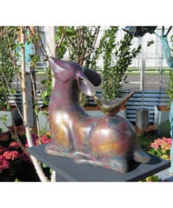 Colourful rabbit sculpture at The Kildare Gallery garden, surrounded by lush plants and vibrant flowers.
