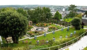 Vibrant garden at The Kildare Gallery showcasing sculpture art and landscaped beauty with city views.