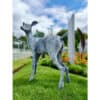 Stainless steel deer sculpture at The Kildare Gallery, outdoor art installation in lush garden setting.