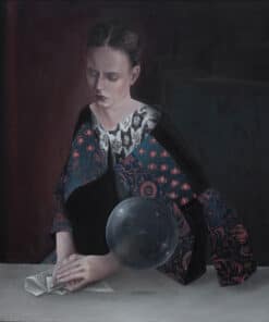 Reflective woman reading with crystal ball at The Kildare Gallery, showcasing contemporary fine art in Ireland.