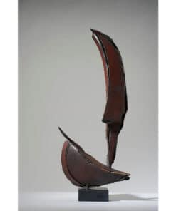Rustic abstract metal sculpture with curved, jagged forms, displayed on a black base.