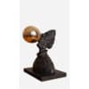 Shaped bronze sculpture with a polished gold sphere on a textured dark base. Art piece displayed at The Kildare Gallery.