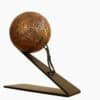 Rustic bronze ball sculpture with metal stand, modern art piece from The Kildare Gallery.