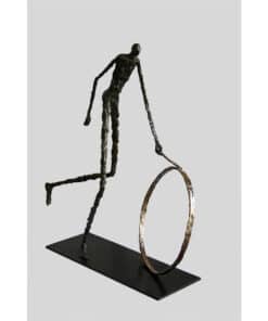 Contemporary bronze sculpture of an abstract figure riding a unicycle, displayed at The Kildare Gallery.