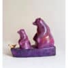 Vibrant purple ceramic bear sculpture with a small bird, contemporary art piece from The Kildare Gallery.