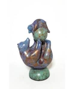 Intricate bronze sculpture featuring a whimsical figure with a spherical head and expressive pose.