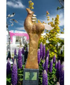Titan horse sculpture garden art at The Kildare Gallery with vibrant purple lupins and blue sky backdrop.