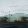 Reflection of industrial buildings and power lines in a glass window - The Kildare Gallery contemporary art.