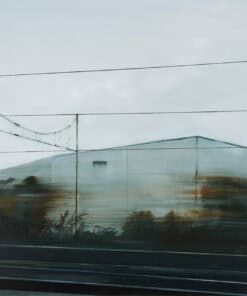 Reflection of industrial buildings and power lines in a glass window - The Kildare Gallery contemporary art.