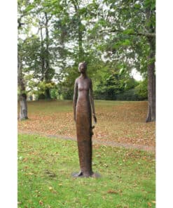 Elegant bronze sculpture of a woman in a lush park setting, part of The Kildare Gallery outdoor art collection.