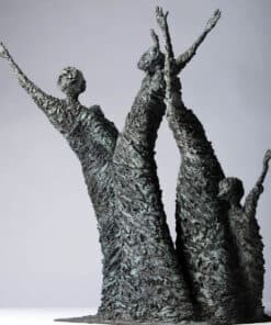 A sculpture of multiple figures with raised arms, crafted with a textured metallic finish.