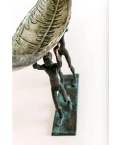 Intricate bronze sculpture of two figures supporting a decorative bowl at The Kildare Gallery.