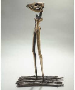 Intricate metallic sculpture of a dinosaur skull with elongated legs at The Kildare Gallery.