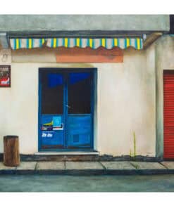 Old shopfront with vibrant blue doors and striped awning in Kildare, Ireland.