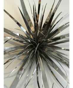 Shiny metallic sculpture with elongated strips, modern art piece at The Kildare Gallery.