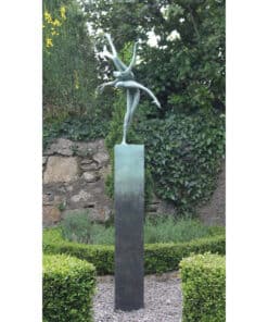 Graceful ballet dancer sculpture in a lush garden setting.