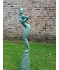 Bronze sculpture of a stylised woman standing on a pedestal against a brick wall.