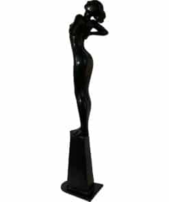Elegant black sculpture of a woman with arms raised, exhibited at The Kildare Gallery.