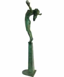 Modern abstract sculpture of a human figure with arms raised, displayed on a pedestal at The Kildare Gallery.