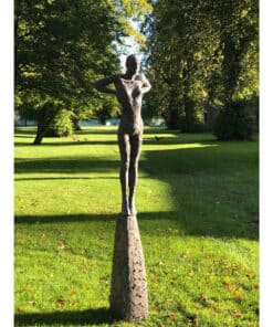 Stone woman sculpture in a lush green park at The Kildare Gallery, showcasing contemporary outdoor art.