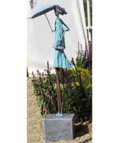 Whimsical bronze sculpture of a woman with an umbrella at The Kildare Gallery.