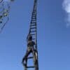Ladder sculpture outside The Kildare Gallery against blue sky, contemporary art piece display.