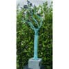 Bright blue artistic metal tree sculpture with black birds, set against lush green foliage, at The Kildare Gallery.