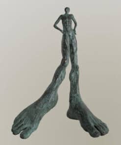 Bronze sculpture of a human figure with exaggerated feet, modern art piece at The Kildare Gallery.