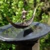 Rustic bronze sculpture of a man with a spear on a leaf-shaped water fountain at The Kildare Gallery garden.
