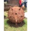 Spiked wooden spherical sculpture outdoor art installation at The Kildare Gallery in Ireland.