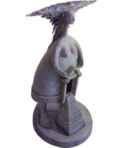 Bronze sculpture of a mythological female figure with flowing hair, holding a saw and standing on a circular base.