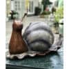 Snail sculpture by The Kildare Gallery, featuring intricate ceramic art of a snail with a metallic shell.