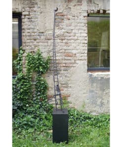 Limestone wall with contemporary metal sculpture displayed outside The Kildare Gallery, showcasing modern art in a historic setting.