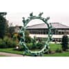 Dynamic bronze sculpture of human figures forming an arch at The Kildare Gallery, surrounded by lush gardens in Ireland.