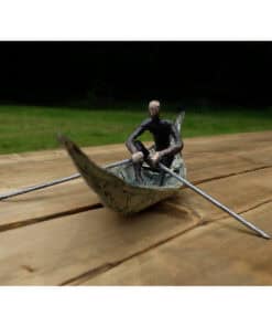 Miniature sculpture of a person rowing a boat on a wooden surface, part of The Kildare Gallery art collection.