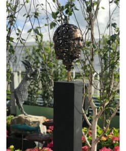 Intricate metal head sculpture displayed outdoors at The Kildare Gallery.