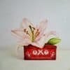 Pink lily in a vintage OXO tin container, artistically painted with realistic detail and vibrant colours.
