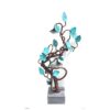Vivid copper sculpture of a twisting tree with turquoise leaves, elegant art piece at The Kildare Gallery.