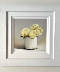 Delicate white peonies in a simple white vase, framed in a contemporary white border.
