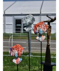 Bold artistic sculptures of female busts with colorful hair, displayed outdoors at The Kildare Gallery.