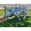 Shiny metal pig sculpture outside Kildare Gallery, modern art piece, public outdoor display.