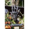 Intricately forged bronze sculpture of a hand titled "Heavy Hand" displayed outdoors at The Kildare Gallery.