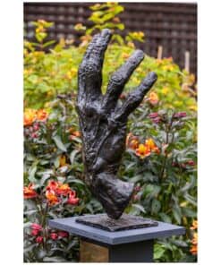 Bronze sculpture of a hand in garden at Kildare Gallery, Irish contemporary art, outdoor sculpture display.