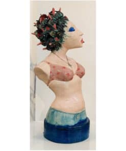 Colourful ceramic sculpture of a woman with elaborate hair, bright makeup, and casual clothing.