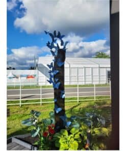 Blue butterfly garden sculpture at The Kildare Gallery in Ireland, surrounded by vibrant plants and outdoor exhibits.