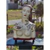 Antique ceramic sculpture of a woman with floral motifs, displayed outdoors at The Kildare Gallery.