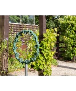 Bronze garden sculpture with lush greenery at The Kildare Gallery outdoor exhibit.