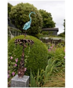 Shorebird sculpture art piece with vibrant blue patina, set in lush garden at The Kildare Gallery, Ireland.